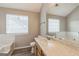 Primary bathroom with double windows, a large vanity mirror, and a tub at 2635 Carolina Rdg, Riverdale, GA 30296