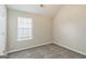 Bedroom with neutral walls, plush carpeting, a large window, and a white door at 2635 Carolina Rdg, Riverdale, GA 30296