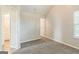 Neutral bedroom boasts plush carpet and view of the attached bath and closet at 2635 Carolina Rdg, Riverdale, GA 30296