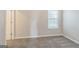 Bright bedroom with plush carpeting, a large window, and a white door at 2635 Carolina Rdg, Riverdale, GA 30296