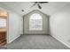 Spacious bedroom featuring a vaulted ceiling, ceiling fan, and large window overlooking the street at 2635 Carolina Rdg, Riverdale, GA 30296