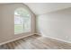 Bright bedroom with vaulted ceilings, hardwood floors, and a large window with tree views at 2635 Carolina Rdg, Riverdale, GA 30296