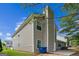 Side angle of a two-story home featuring vinyl siding, a concrete patio, and a tall chimney at 2635 Carolina Rdg, Riverdale, GA 30296