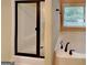 Bright bathroom with tub and shower combo next to the soaking tub at 513 Cherry Creek Dr, Loganville, GA 30052