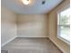 Large bedroom with carpet, base trim, and two sunny windows at 513 Cherry Creek Dr, Loganville, GA 30052