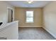 Cozy bedroom with neutral carpet and a large window providing natural light at 513 Cherry Creek Dr, Loganville, GA 30052