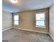 Bedroom with plush carpet, neutral paint, and a pair of sunny windows at 513 Cherry Creek Dr, Loganville, GA 30052