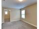 Bedroom view showcases neutral tones and plush carpet, plus entry to another room at 513 Cherry Creek Dr, Loganville, GA 30052