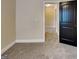 Bedroom view showcasing neutral paint and plush carpet plus a modern black door at 513 Cherry Creek Dr, Loganville, GA 30052