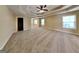 Large bedroom with tray ceilings, neutral carpet and paint, large windows and an arched entryway at 513 Cherry Creek Dr, Loganville, GA 30052