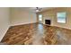 Inviting living room featuring a cozy fireplace, large windows, and hardwood flooring at 513 Cherry Creek Dr, Loganville, GA 30052