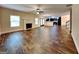 Bright living room with a fireplace, large windows, and an open layout leading to the kitchen at 513 Cherry Creek Dr, Loganville, GA 30052