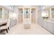 Large bathroom with a soaking tub, dual vanities, mirrors, and natural light at 105 Godby Dr, Fayetteville, GA 30215