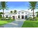 Beautifully landscaped property featuring an elegant home and well-maintained lawn with palm trees at 105 Godby Dr, Fayetteville, GA 30215