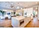 A bright, open kitchen with white cabinetry, stainless appliances, and views to the living area and dining room at 105 Godby Dr, Fayetteville, GA 30215