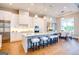 A spacious kitchen features white cabinets, stainless appliances, pendant lighting, and an island with seating at 105 Godby Dr, Fayetteville, GA 30215
