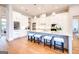 The modern white kitchen with an island boasts stylish seating, high-end appliances, and wood floors at 105 Godby Dr, Fayetteville, GA 30215