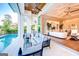An elegant living room flows to an outdoor space featuring a pool and stylish furnishings, perfect for relaxation and entertainment at 105 Godby Dr, Fayetteville, GA 30215