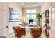 Home office with natural light, neutral walls, hardwood floors, and built-in bookshelves at 105 Godby Dr, Fayetteville, GA 30215