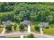 An aerial view of a well-maintained neighborhood, featuring tree-lined streets and beautifully landscaped yards at 1028 Gloria Grand Blvd, Mcdonough, GA 30252