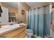 A cozy bathroom with a vanity sink, toilet, and a shower featuring a patterned curtain and neutral color palette at 1028 Gloria Grand Blvd, Mcdonough, GA 30252