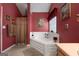 Bathroom featuring a corner tub, neutral walls, and fixtures at 1028 Gloria Grand Blvd, Mcdonough, GA 30252
