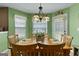 Bright dining area with wood table, chairs, and a decorative Tiffany-style light fixture at 1028 Gloria Grand Blvd, Mcdonough, GA 30252