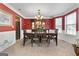 Traditional dining room featuring a wood table, chairs, chandelier, and built-in hutch at 1028 Gloria Grand Blvd, Mcdonough, GA 30252