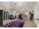 A luxurious dressing room with a vanity, chandelier, plush seating, and accessory displays in a spacious, well-lit area at 1028 Gloria Grand Blvd, Mcdonough, GA 30252