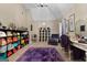 A dressing room with a purple rug, vanity, jewelry display, and organized handbag storage creates a stylish, functional space at 1028 Gloria Grand Blvd, Mcdonough, GA 30252