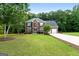 Beautifully landscaped two-story brick home with well-manicured lawn and a two car garage at 1028 Gloria Grand Blvd, Mcdonough, GA 30252