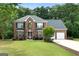 Attractive two-story brick home with a manicured lawn and attached two-car garage at 1028 Gloria Grand Blvd, Mcdonough, GA 30252