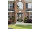 Close-up of a brick home's front door with sidelights and decorative trim at 1028 Gloria Grand Blvd, Mcdonough, GA 30252