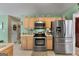 Bright kitchen featuring stainless steel appliances and wood cabinets at 1028 Gloria Grand Blvd, Mcdonough, GA 30252