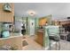 Charming kitchen with light green walls, breakfast bar, and view into the dining room at 1028 Gloria Grand Blvd, Mcdonough, GA 30252
