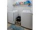 Functional laundry room featuring a washer, dryer, and shelving for storage at 1028 Gloria Grand Blvd, Mcdonough, GA 30252