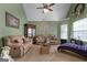 Comfortable living room with plush sofas, a display cabinet, and natural light at 1028 Gloria Grand Blvd, Mcdonough, GA 30252