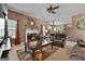 Open concept living room with fireplace, comfortable sofas, and view into the kitchen at 1028 Gloria Grand Blvd, Mcdonough, GA 30252