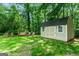 A charming shed with a swing and chairs, nestled in a lush, green backyard at 1028 Gloria Grand Blvd, Mcdonough, GA 30252