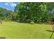 Expansive backyard with lush green lawn and mature trees, ideal for outdoor activities at 1070 Elaine Dr, Forest Park, GA 30297