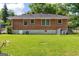 View of the spacious backyard, showing the brick home and green lawn at 1070 Elaine Dr, Forest Park, GA 30297