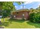 Brick home with a fenced-in backyard, showcasing mature trees and a well-maintained lawn at 1070 Elaine Dr, Forest Park, GA 30297