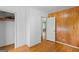 Bedroom featuring hardwood floors, closet, paneled wall, and white door at 1070 Elaine Dr, Forest Park, GA 30297