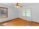 Bright bedroom featuring hardwood floors, two windows, and a ceiling fan at 1070 Elaine Dr, Forest Park, GA 30297