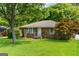 Lovely brick home featuring a well-manicured lawn and beautiful front yard landscaping at 1070 Elaine Dr, Forest Park, GA 30297
