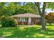 Charming brick home with well-maintained lawn, mature landscaping, and inviting curb appeal at 1070 Elaine Dr, Forest Park, GA 30297