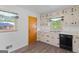 Kitchen with sleek appliances, laminate flooring, decorative curtains and ample counter space at 1070 Elaine Dr, Forest Park, GA 30297