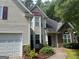 Close-up of an inviting two-story home featuring stone accents, vinyl siding, and a well-maintained lawn at 5327 Yoshino Ter, Powder Springs, GA 30127