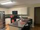 Functional kitchen with dark countertops, wood cabinets, and a breakfast bar at 5327 Yoshino Ter, Powder Springs, GA 30127