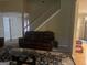 View of the living room with leather seating, a staircase, and neutral walls, perfect for relaxing or entertaining at 5327 Yoshino Ter, Powder Springs, GA 30127